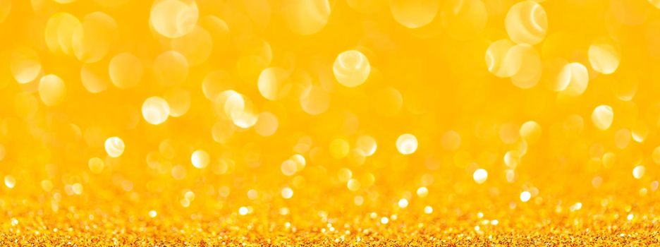 sparkles of yellow glitter abstract background. Copy space. Banner