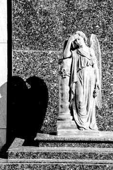 Metal Angel statue in a lonely cemetery in Spain