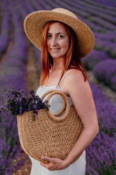 charming Young woman with a hat and white dress in a purple lavender field. LIfestyle outdoors. Back view.