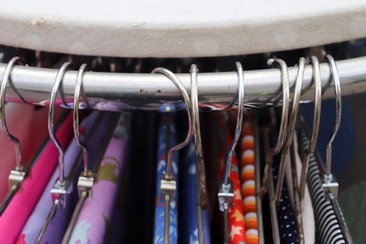 Detailed close up view on samples of cloth and fabrics in different colors found at a fabrics market.