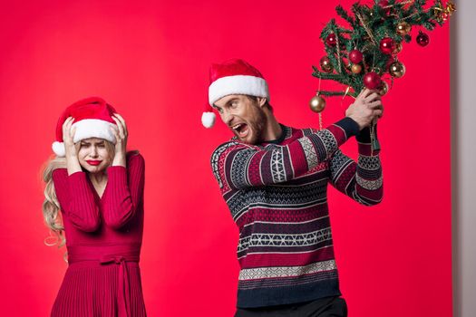 a man and a woman are standing next to Christmas decorations fun holiday. High quality photo