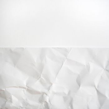 a smooth white paper surface and a crumpled paper side by side