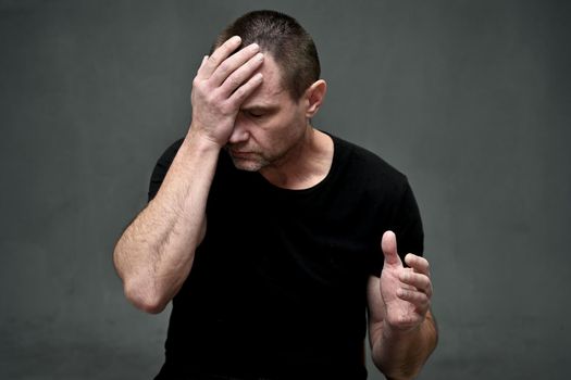 portrait of caucasian man upset in depression holding his head with his hands