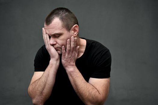 portrait of a man worried upset with his hands covering his face