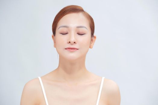 Woman with beauty face touching healthy facial skin portrait.
