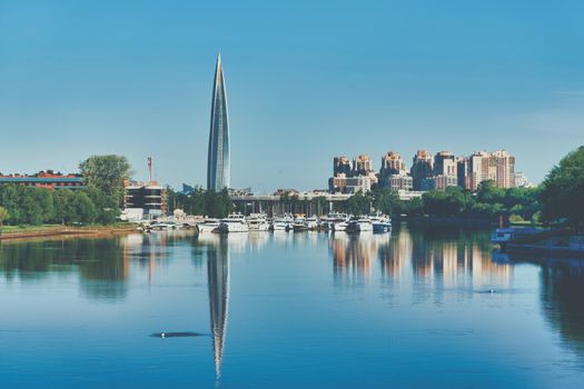 Skyscraper of Gazprom in St. Petersburg with fucking in river against background of a blue sky, cityscape on summer sunny day