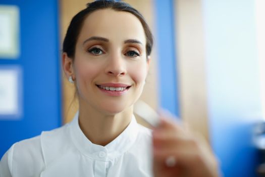 Portrait of beautiful office worker female touch virtual screen with silver pen. Make corrections on modern virtual device. Business, development concept