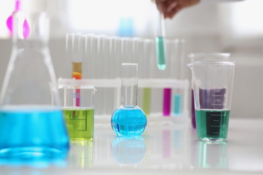 Close-up of working mess, lab tubes stand on table in laboratory of liquid testing, test development, substances poisons. Chemistry, medicine, lab concept