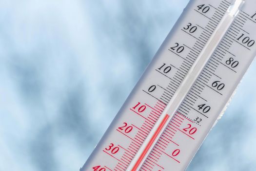 Thermometer in winter in the cold on snow and analyzes low negative air temperatures in clear sunny weather.Meteorological conditions and environmental analysis.Climate change on earth.Northern region