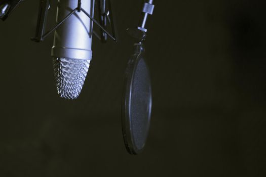 Professional microphone suspended in the air of professional studio