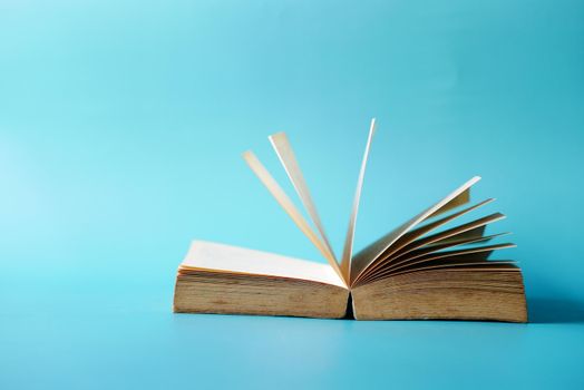 open book and a pencil on wooden table.
