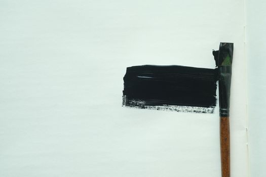 art brush and black color paint on paper .