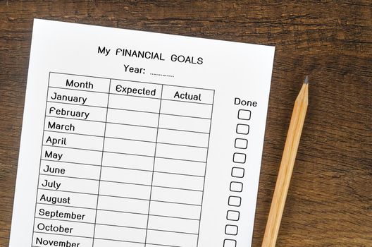 My planning financial goals form and wooden pencil.