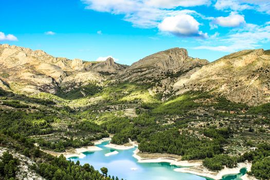 The swamp of Guadalest village surrounded by vegetation and mountains on a sunny day