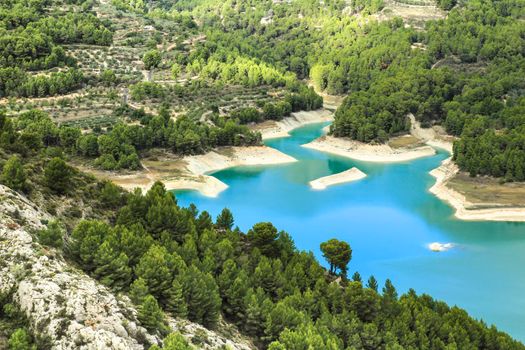 The swamp of Guadalest village surrounded by vegetation and mountains on a sunny day