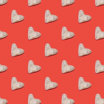 Pattern of stones in the shape of a heart of love for Valentine's Day on a red background.
