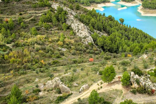 The swamp of Guadalest village surrounded by vegetation and mountains on a sunny day
