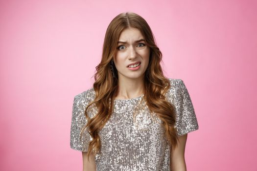 Close-up shot displeased frustrated upset awkward attractive glamour woman freaked-out cringing grimacing aversion disapporval dislike, being upset shocked, standing disappointed pink background.