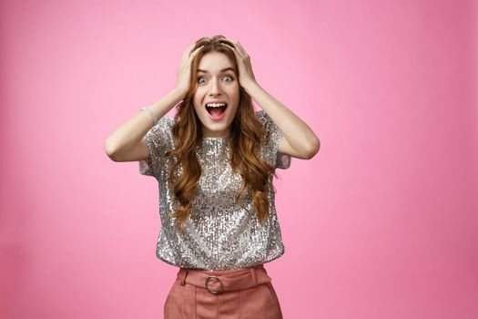 Excited happy surprised charming glamour young girl winning unexpectedly grab head amazed drop jaw smiling look camera astonished thrilled happiness, standing astonished pink background.