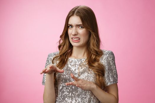 Disgusted reluctant young arrogant glamour woman telling about creepy man cringing aversion grimacing dislike gesturing displeased, expressing antipathy standing pink background freaked-out.