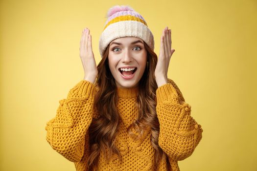 Close-up amused surprised pretty young european woman open eyes smiling broadly reacting astonished happy receiving incredible awesome surprise grinning joyfully celebrating birthday.