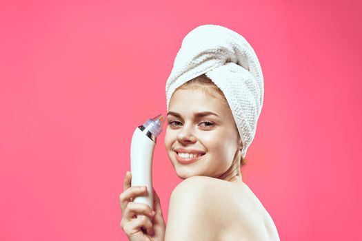 woman with bare shoulders with a towel on her head cleaning the skin. High quality photo