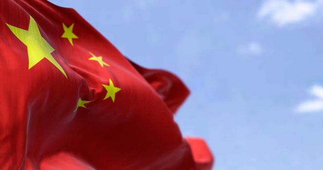 Detailed close up of the national flag of China waving in the wind on a clear day. Democracy and politics. Asian country. Selective focus.