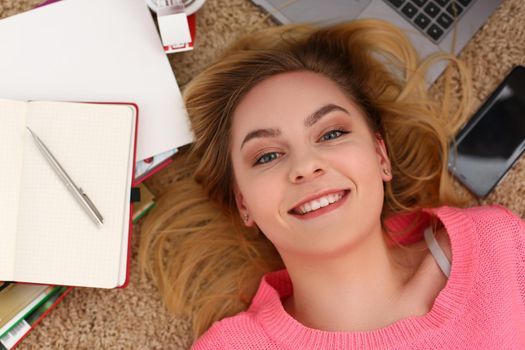 Portrait of beautiful woman lies on floor with diary. Learning and education concept