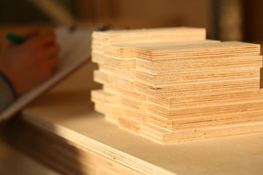 Plank board closeup. Wood plank panel for construction and production furniture. Wood chipboard cutting board warehouse
