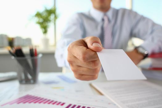 Businessman holds business card in hand. Corporate business card concept