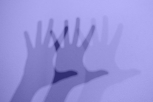 Monochrome shadows of a hand dancing to the music. Interactive exposition in science museum. Banner in trendy 2022 color.