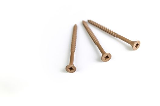 A pile of 3 inch Brown Deck Screws Isolated on a White Background. High quality photo