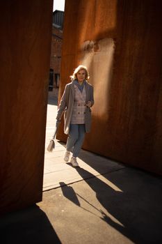 Girl against a rusty wall outdoor. High quality photo