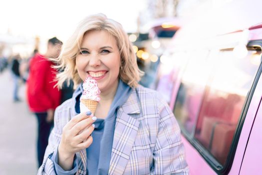 Super happiness girl holding ice cream in the right hand. High quality photo