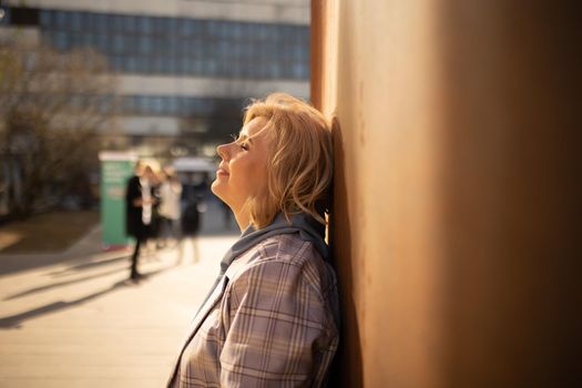 Girl against a rusty wall outdoor. High quality photo