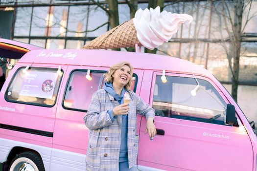 Super happiness girl holding ice cream in the right hand. High quality photo