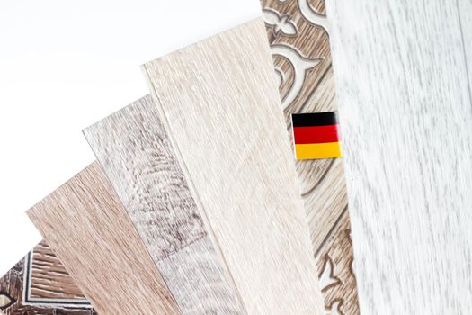 Linoleum. Samples of flooring. Laying of linoleum. German quality. German flag. Linoleum roll with wood texture.