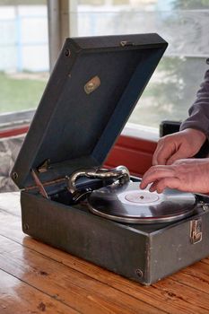 The gramophone record is played on the old potiphon. Old turntable