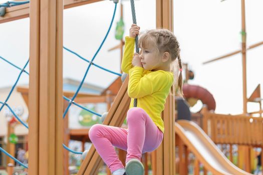 cute baby playing and climbing on the playground. Physical, Hand Coordination, Sensory, Motor Skills development concept