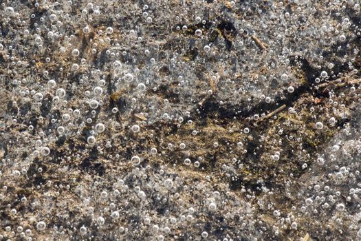 Air bubbles in the frozen water, ice background