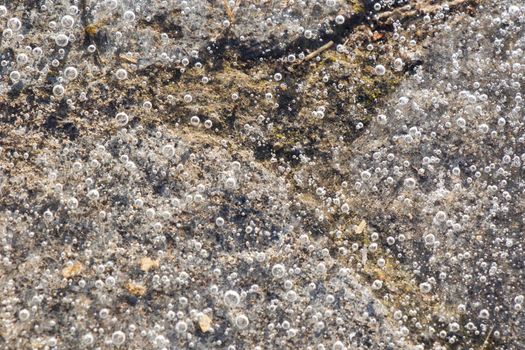 Air bubbles in the frozen water, ice background