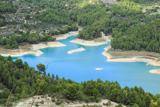 The swamp of Guadalest village surrounded by vegetation and mountains on a sunny day
