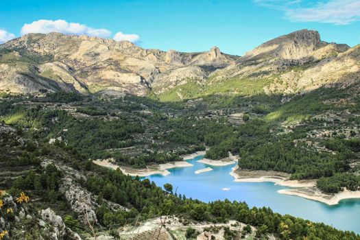The swamp of Guadalest village surrounded by vegetation and mountains on a sunny day
