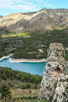 Beautiful view of Guadalest village surrounded by vegetation, mountains and the walls of the Castle