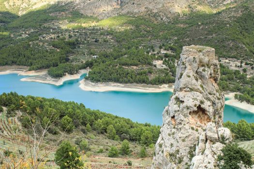 Beautiful view of Guadalest village surrounded by vegetation, mountains and the walls of the Castle