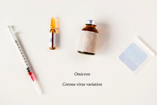 Omicron, corona virus variation. Vaccine ampule and needle on the white background, virus vaccine