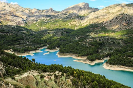 The swamp of Guadalest village surrounded by vegetation and mountains on a sunny day