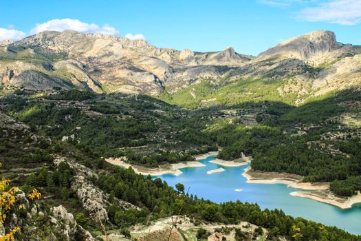 The swamp of Guadalest village surrounded by vegetation and mountains on a sunny day