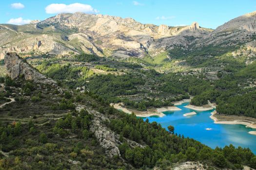 The swamp of Guadalest village surrounded by vegetation and mountains on a sunny day