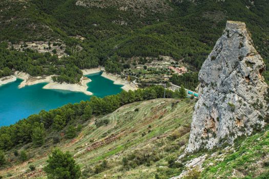 Beautiful view of Guadalest village surrounded by vegetation, mountains and the walls of the Castle